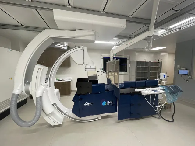 EggNest installed on the procedure table of a cath lab, with the C-arm and monitors around it